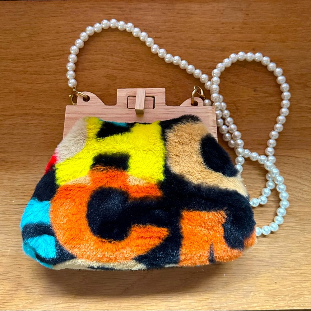 Purse with printed faux fur detail and pearl strap